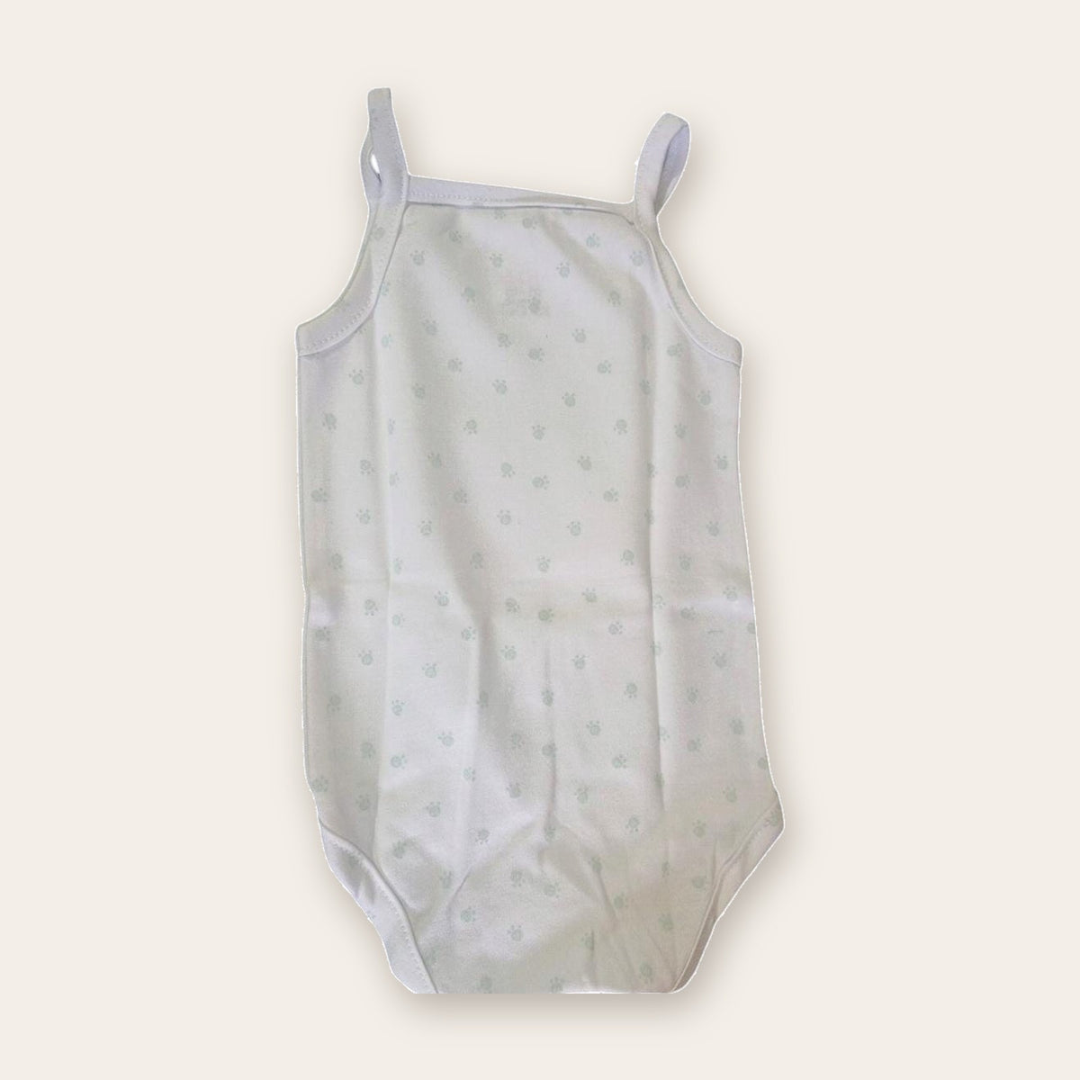 Strappy Printed Baby Bodysuit – White / Footsteps – front, styled