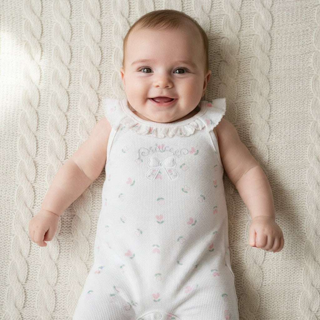 Baby wearing flutter-sleeve waffle romper, tulip print