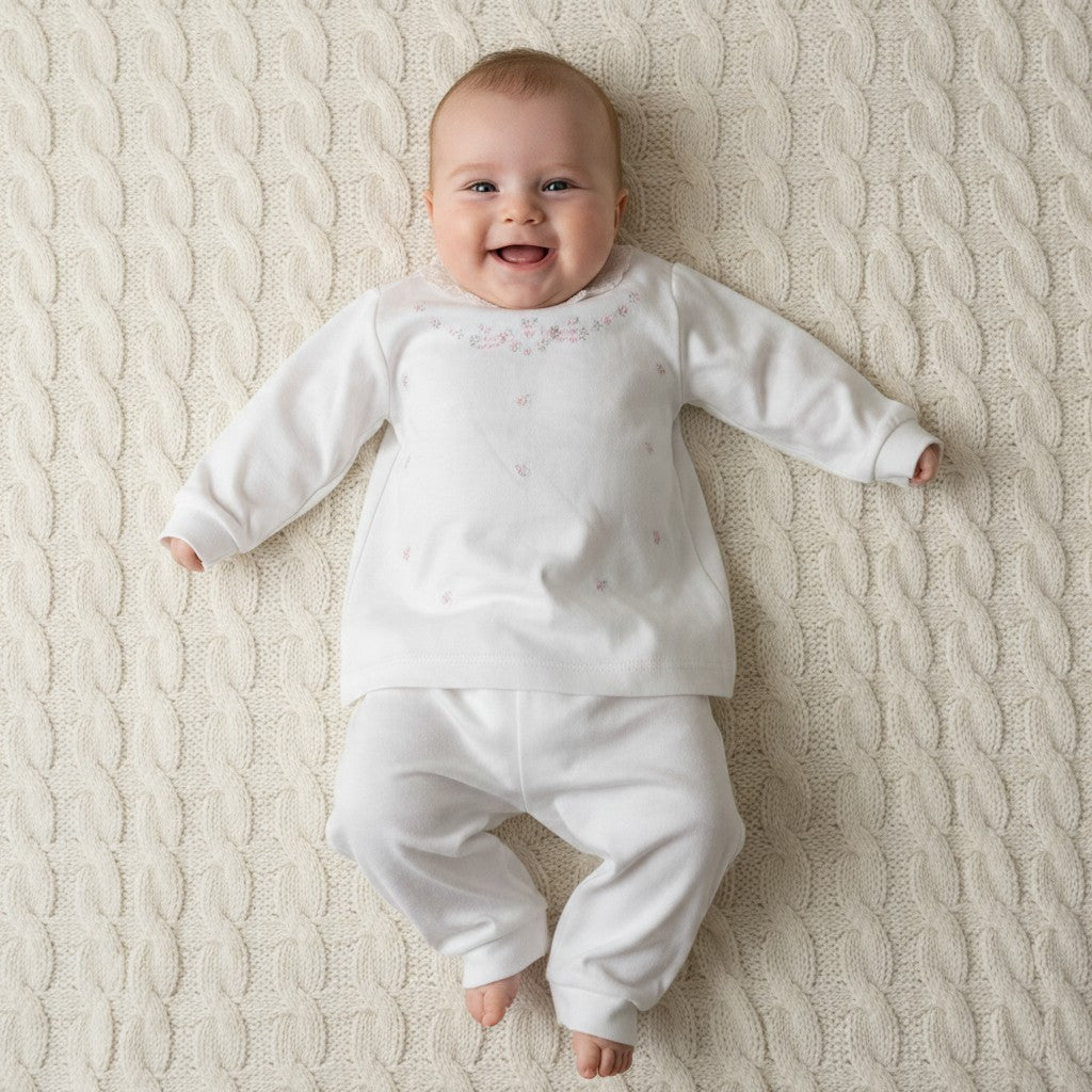 Baby wearing white embroidered floral 2-piece set